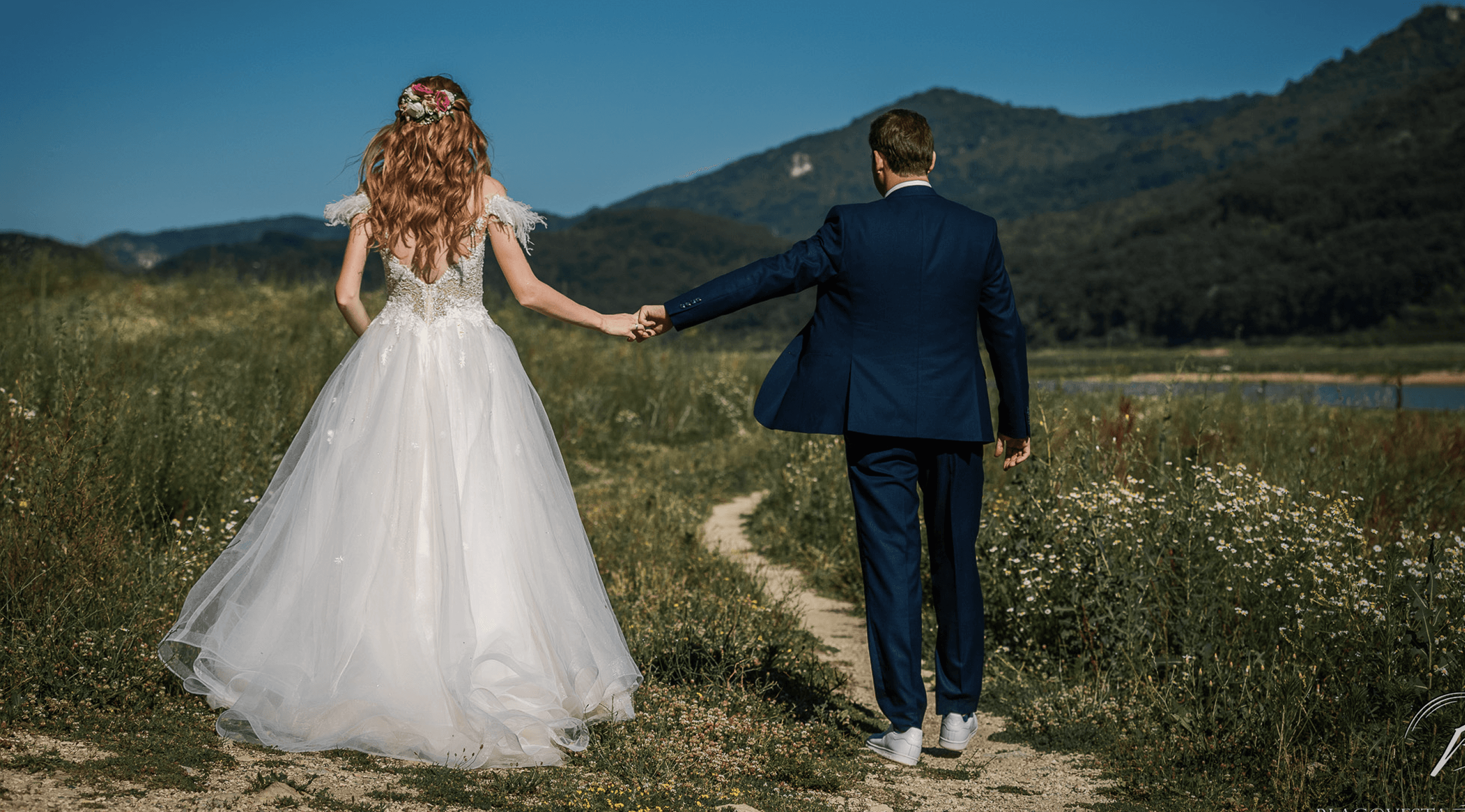 Newlyweds walking through the countryside near Ovech Resort Complex